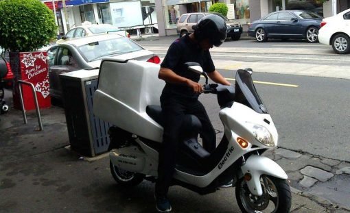 Man On Electric Motorbike With Cargo Box